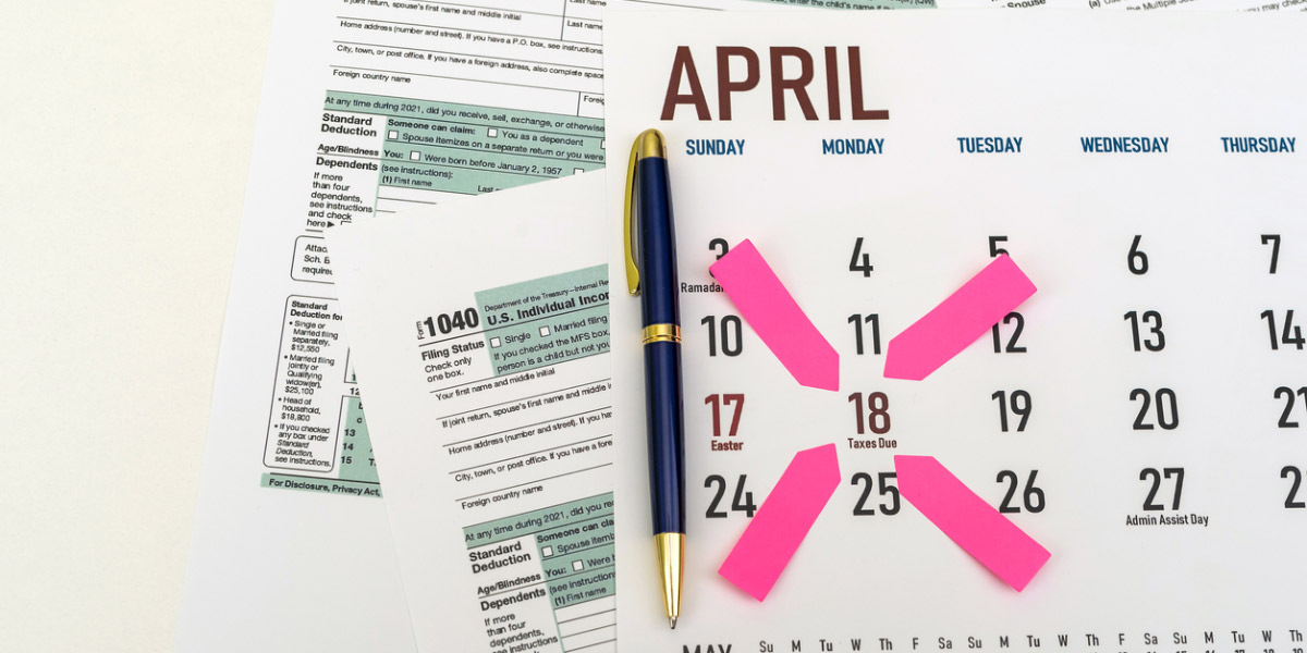 Tax forms and next to the calendar with a date mark when you need to file a return.