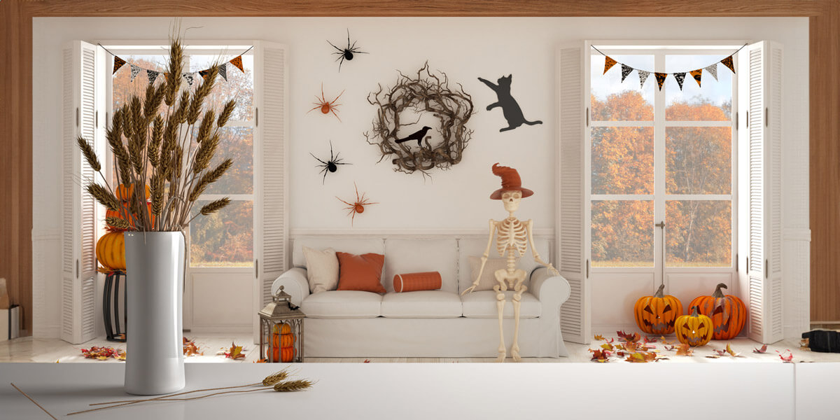 White table top or shelf with straws, dry plants, ornament, ears, sheaf, branch in vase, over Halloween living room with fireplace and autumnal landscape, classic interior design.