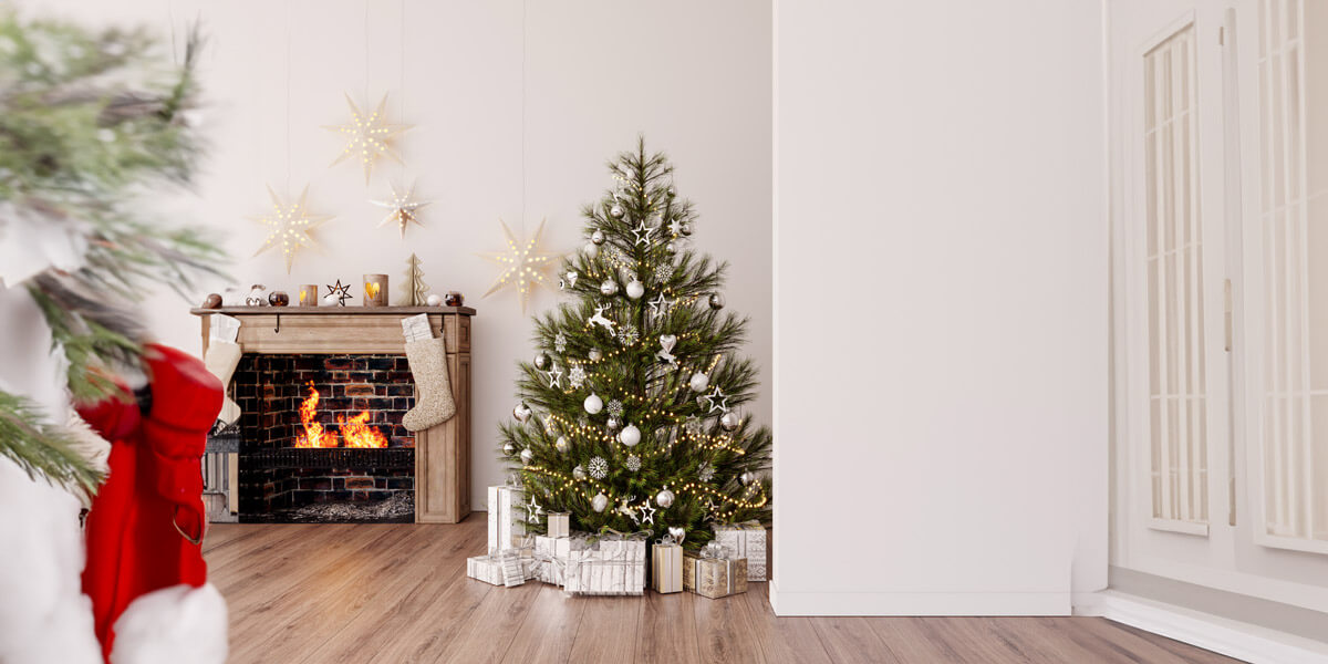 A cozy room with a beautifully decorated Christmas tree and a warm fireplace crackling with holiday cheer.