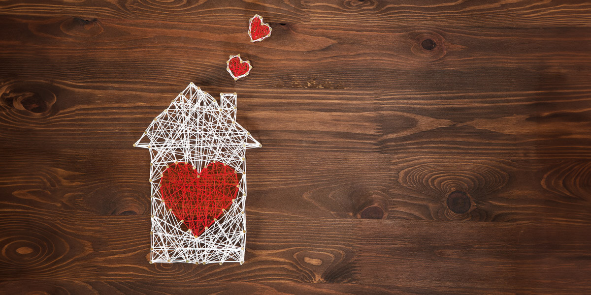 A charming string house adorned with hearts, including a prominent red heart.