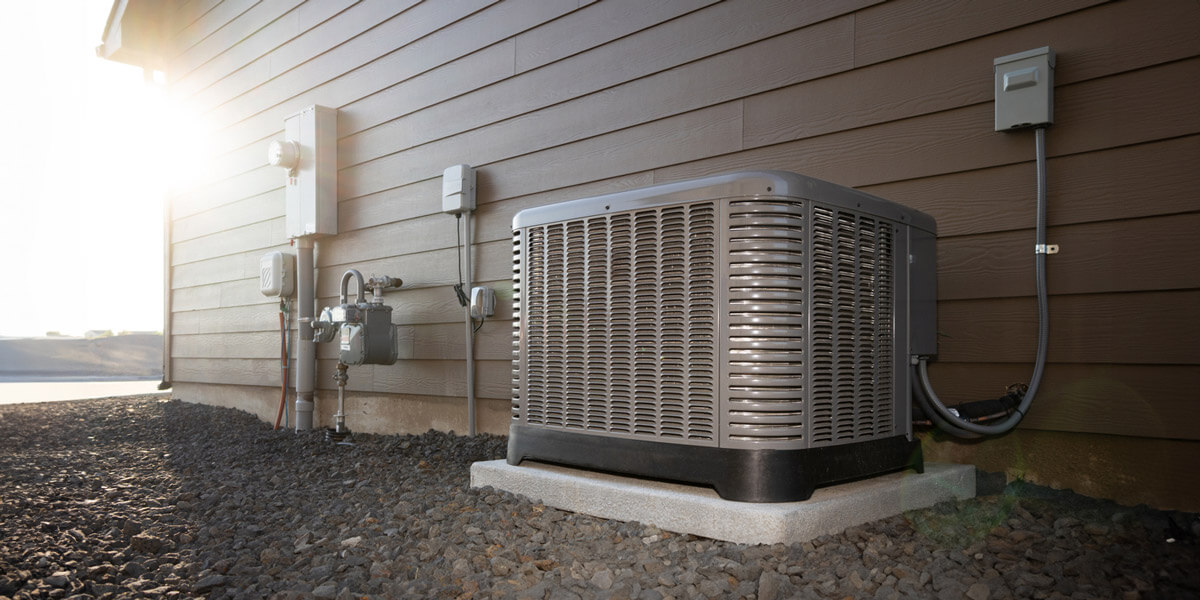 An exterior view of a house featuring a heat pump installed beside it, showcasing modern energy-efficient technology.